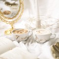 Zestaw 2 białych filiżanek porcelanowych 250 ml ze spodkami - złoty napis Mąż Żona dla pary na rocznicę ślubu Biały filiżanka porcelanowa nadzwyczajnie.mom ze złotym zdobieniem i napisem filiżanek 250 ml ze spodkami - Mąż Żona ZŁOTY