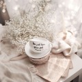 Biała filiżanka porcelanowa ze spodkiem 250 ml - napis Dom jest tam gdzie jest mama ze złotym sercem dla mamy na Dzień Matki Zbliżenie na złote zdobienie serca na białym filiżance porcelanowej ze spodkiem - Dom jest tam, gdzie jest mama